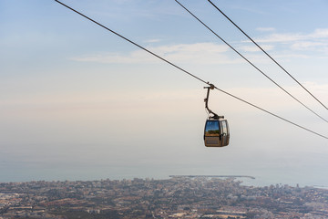 cable car in the mountains against the background of the city