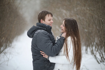 pair of lovers on a date winter afternoon in a snow blizzard