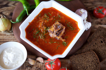 Delicious rich borscht with beef is on the table in the restaurant.