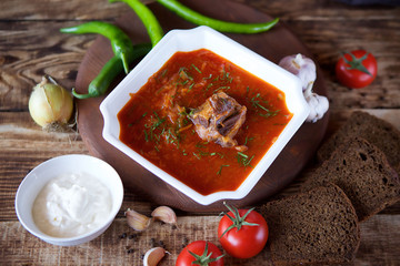 Delicious rich borscht with beef is on the table in the restaurant.