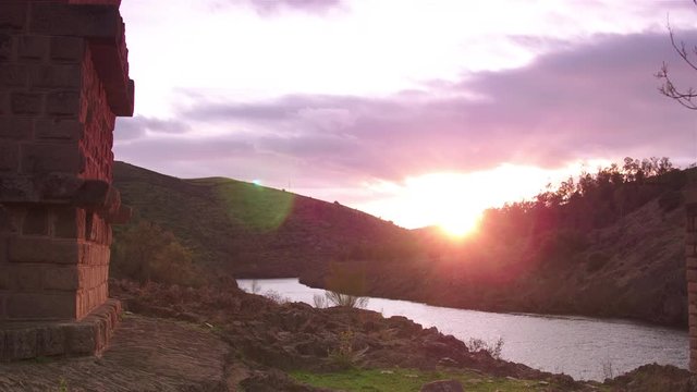 The sun sets through Alc&radic;&deg;ntara Bridge