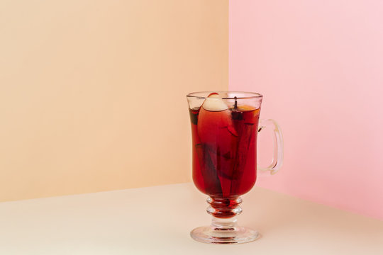 Mulled wine in glass on the glass table. Winter concept