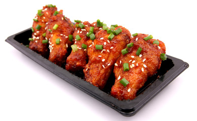Korean fried chicken with white backdrop.