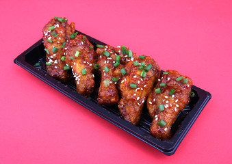 Korean chicken fried with pink background.
