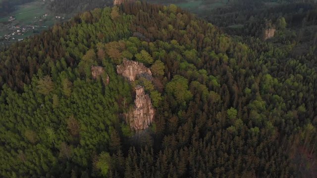 Flying backwards over Sokoliki mountain and Krzywa Turnia crag. Sokole mountain range, Poland.