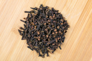 Whole clove heads and pieces isolated over white