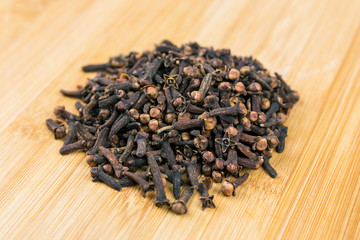 Whole clove heads and pieces isolated over white