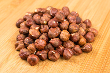 Pile of whole unshelled hazelnuts isolated