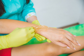 woman making sugaring in cosmetic center. epilation beauty. hands close up