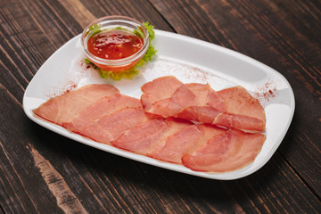 White plate with dried  mieat slices as beer snack