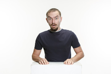 Wow. Attractive male half-length front portrait on studio backgroud. Young emotional surprised bearded man with open mouth. Human emotions, facial expression concept