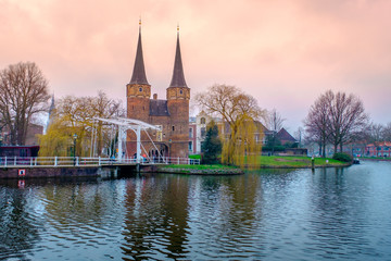Evening view of the canal and the VVE Oostpoort de Delft. Dutch city in the spring after sunset. Holland, Netherlands.