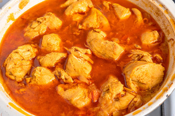 Cooking chicken curry - curry in a pan close-up