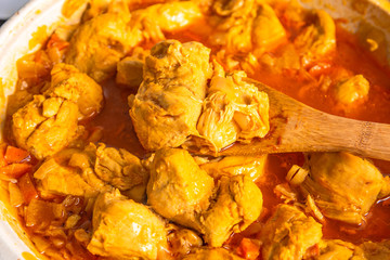 Cooking chicken curry - curry in a pan close-up