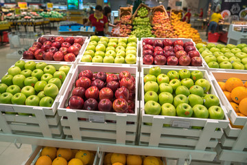 Fresh healthy fruits on shelves in supermarket