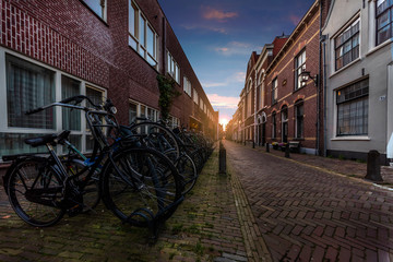 Amsterdam calm street sunset where locals parked their bicycle at the end of the working day