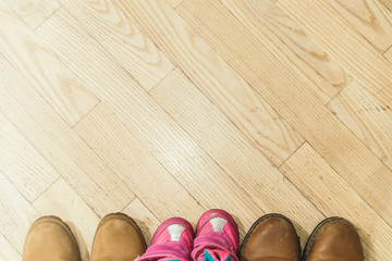 father, mother and daughter shoes. overhead view. copy space