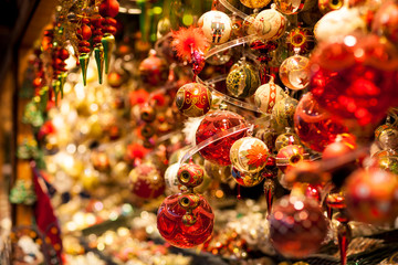 Red and golden christmas tree ornaments and balls, advent market stall close up, photo