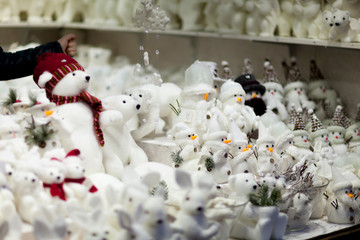 All white christmas gifts souvenirs and toys on the advent market stall: bears, rabbits, snowmen,