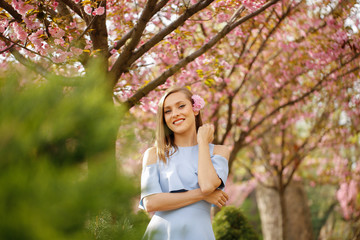 Beautiful girl posing in blue dress in park