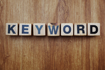 Fototapeta premium keyword word created with cubes alphabet letters on blue background