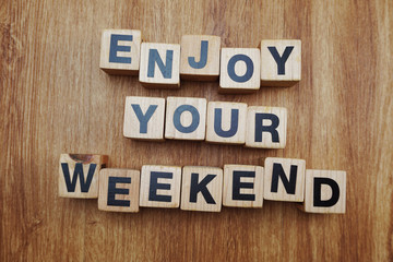 enjoy weekend word alphabet letter on wooden background