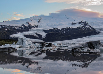Iceberg lagoon Fjallsarlon with floating icebergs and dramatic sky reflection in water, Vatnajokull National Park, Southern Iceland, Europe