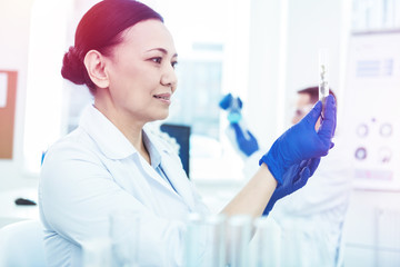 Smart intelligent woman holding a test sample