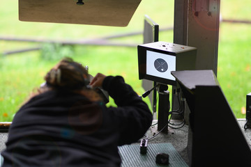 Woman with assault rifle on a shooting range in Switzerland