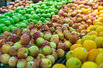 Fresh healthy fruits on shelves in supermarket