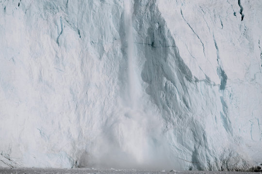 Arctic Glacier calving event from a massive wall of ice