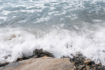 Beautiful strong waves on the stone beach.