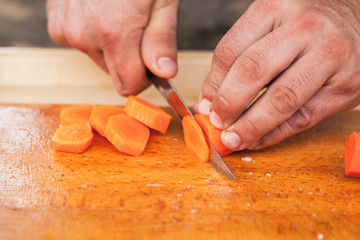 Greens slicing. Hands of cook with knife