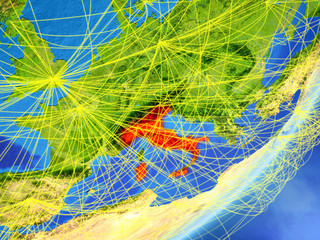 Italy on model of planet Earth with network at night. Concept of new technology, communication and travel.