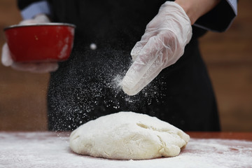 the cook makes flour for baking on the table