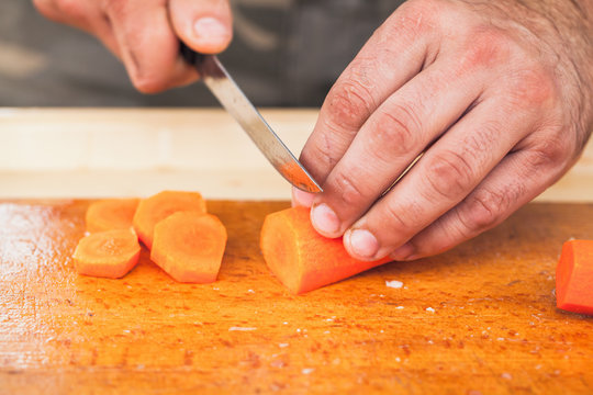 Greens shopping. Hands of cook with knife