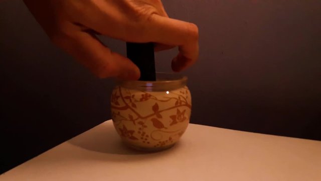 Close up shot of a man that lights candles. Christmas time. Making a cosy  home. Cinamon smell candle.