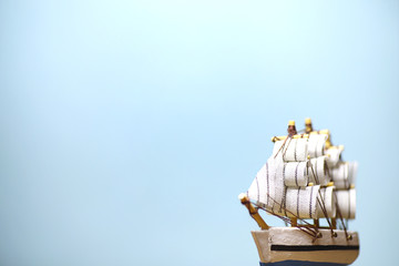 Old wooden ship with sails and masts toy on a stand. Vintage and retro toys.
