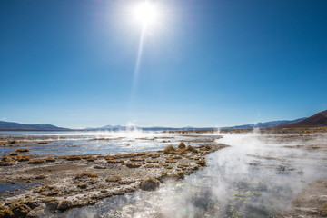 Sunshine surface covered with steam and geysers in Bolivia