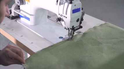 sewing machine in the process, man's hands