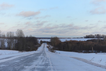 Winter landscape snow covered expanses. A park in the winter in the snow. Road on a winter day.