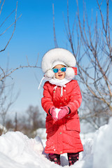 Cute little girl in winter, have fun