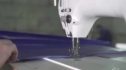 hands of male worker at the factory for sewing machine