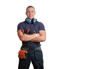 Strong male mechanic in blue overal standing on a white isolated background