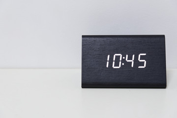 Black digital clock on a white background showing time 10:45