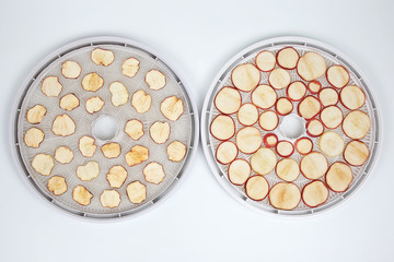 Dried and fresh Apple slices on trays of special electric fruit dryer