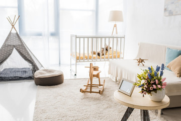 modern interior design of nursing room with crib and baby wigwam © LIGHTFIELD STUDIOS