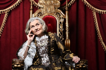 Obraz premium Portrait of beautiful senior woman in vintage dress