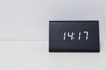 Black digital clock on a white background showing time 14:17