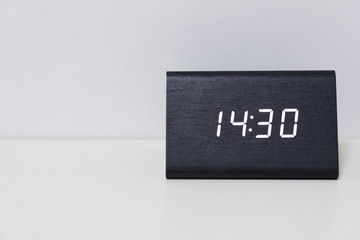 Black digital clock on a white background showing time 14:30